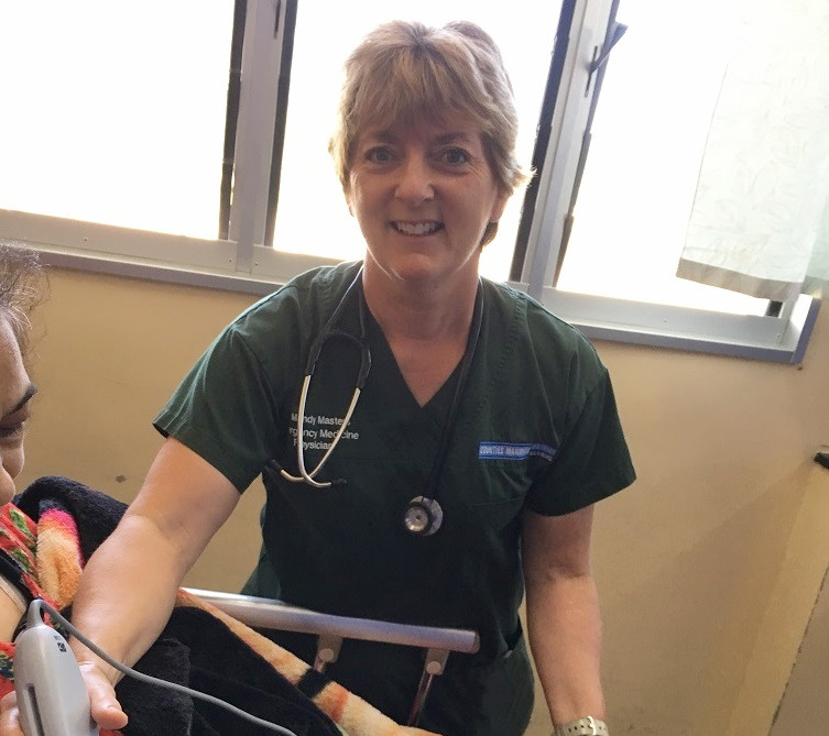 Dr Mandy Masters uses a handheld ultrasound system to scan a patient